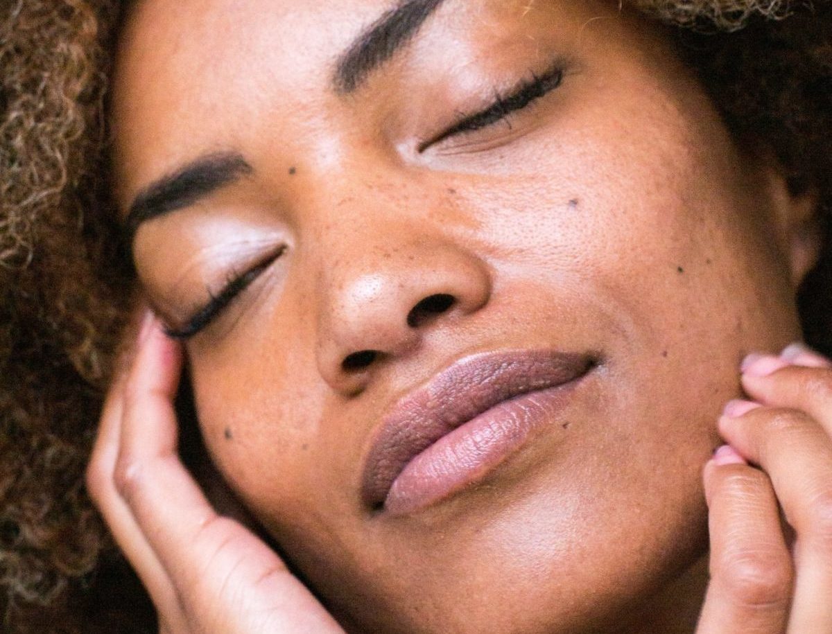 Black woman touching her face