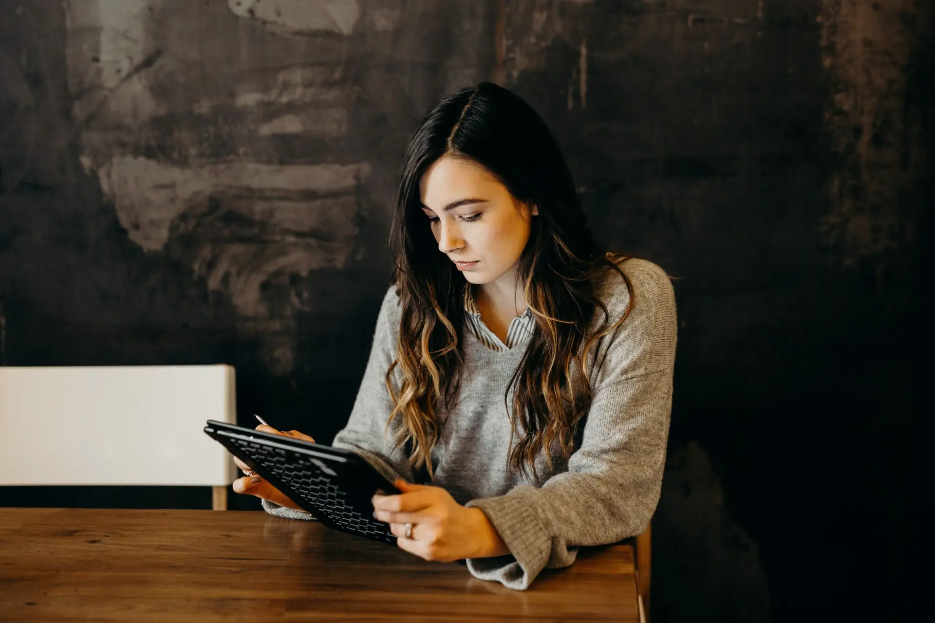data photograph of a woman looking at her tablet